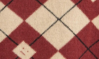 Shop Acne Studios Face Logo Argyle Jacquard Wool Blend V-neck Sweater In Biscuit Beige/ Deep Red