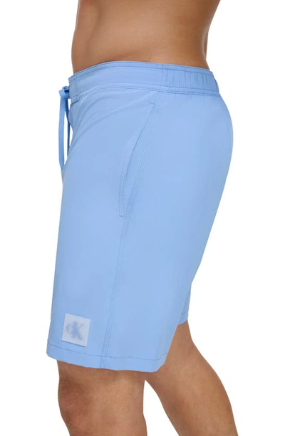 Shop Calvin Klein Solid Stretch Board Shorts In Light Blue