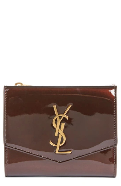 Shop Saint Laurent Cassandre Uptown Patent Leather Trifold Wallet In Ir Brown/ Dark Nut Brown