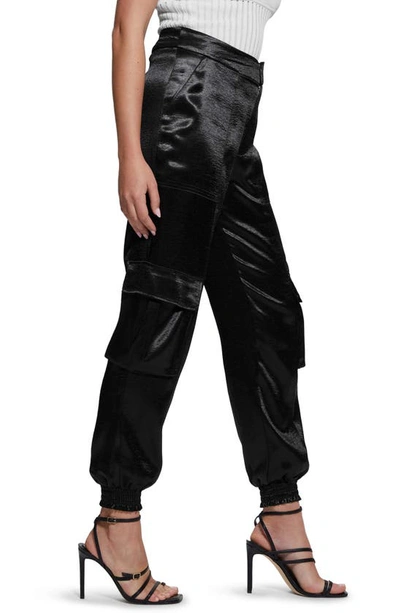 Shop Guess Soundwave Textured Satin Cargo Pants In Jet Black