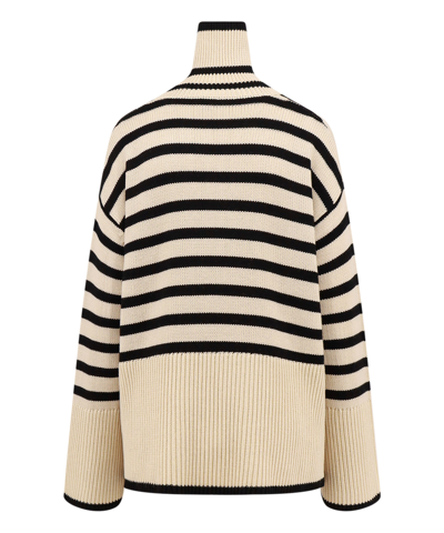 Shop Totême Oversize Roll-neck Sweater In Beige