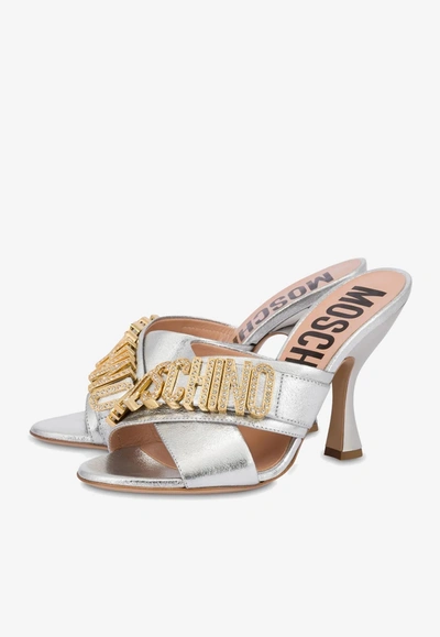 Shop Moschino 100 Crystal Logo Sandals In Metallic Leather In Silver