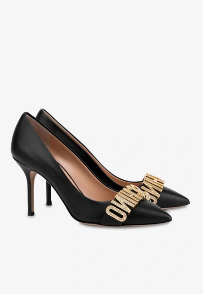 Shop Moschino 85 Crystal Embellished Logo Pumps In Calf Leather In Black