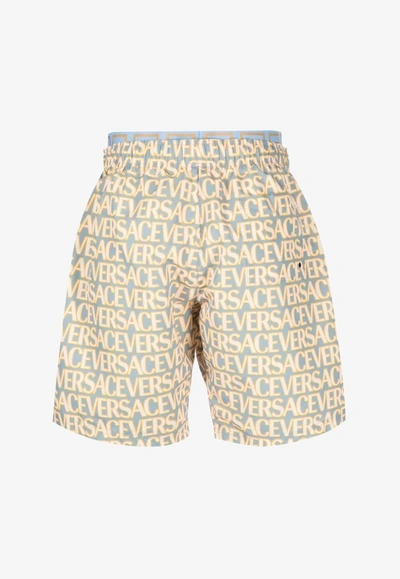 Shop Versace All-over Logo Print Boardshorts In Multicolor