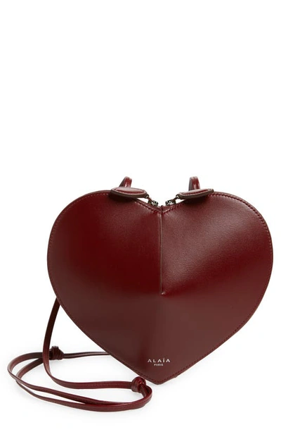 Shop Alaïa Le Coeur Leather Crossbody Bag In 325 - Rouge Grenat