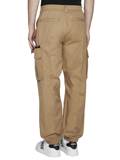 Shop Versace Trousers In Sand