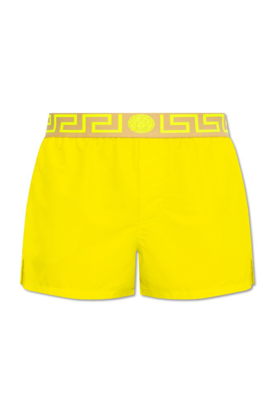 Shop Versace Greca Logo Waistband Swim Shorts In Yellow