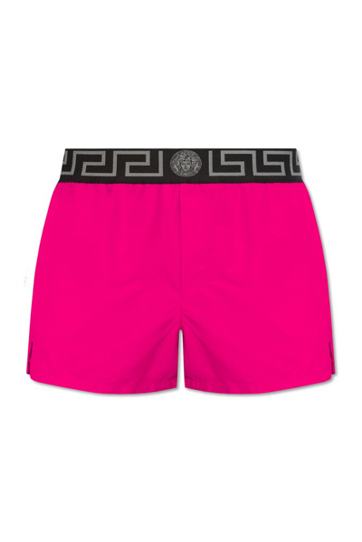 Shop Versace Greca Logo Waistband Swim Shorts In Pink