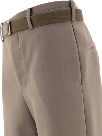 Shop Sacai Belted Trousers In Beige