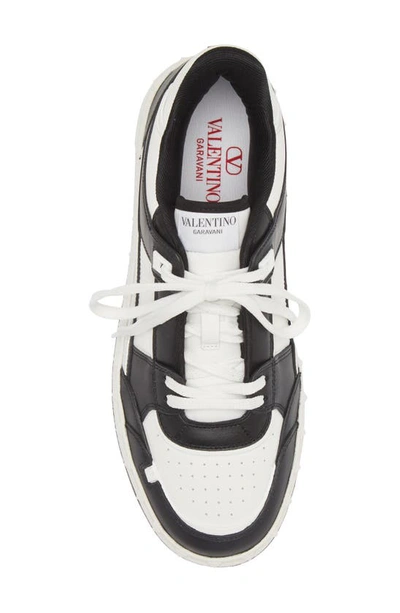 Shop Valentino Rockstud Low Top Sneaker In Bianco/ Nero