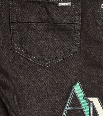 Amiri Distressed Logo Skinny Jeans In Black