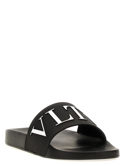Shop Valentino Vltn Sandals White/black