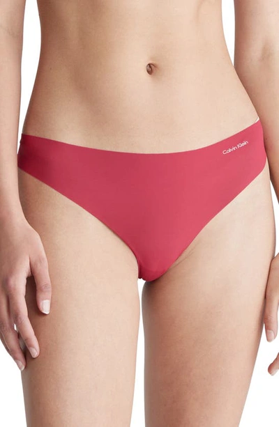 Shop Calvin Klein Invisibles 3-pack Thongs In Heavy Red Bud/ Van