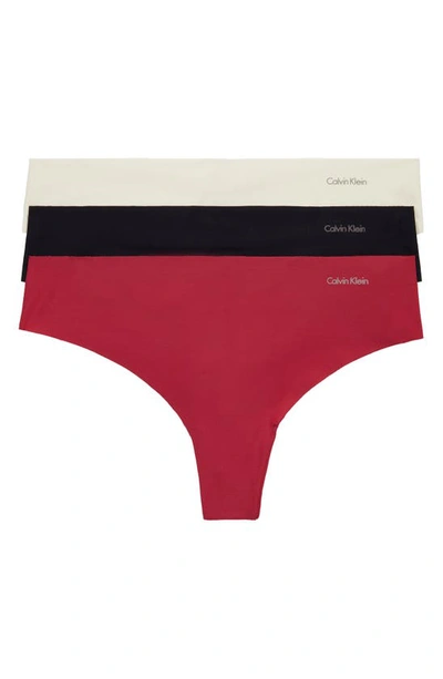 Shop Calvin Klein Invisibles 3-pack Thongs In Heavy Red Bud/ Van