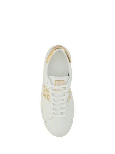 Shop Versace Sneakers In White/gold