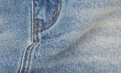 Edikted Distressed Low Rise Denim Miniskirt In Blue