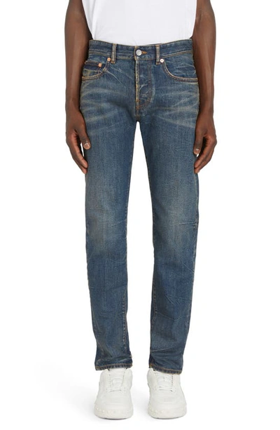 Shop Valentino Carrot Fit V Detail Jeans In Denim Scuro