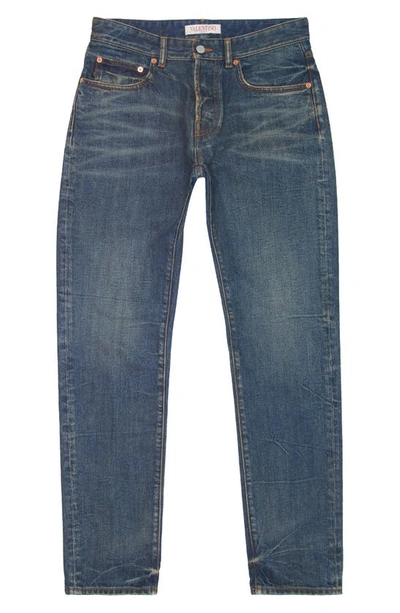 Shop Valentino Carrot Fit V Detail Jeans In Denim Scuro