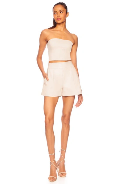 Shop Susana Monaco Faux Leather Pleated Shorts In Blanched Almond