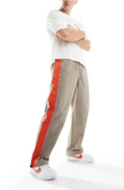 Shop Asos Design Stripe Panel Nylon Wide Leg Drawstring Track Pants In Brown