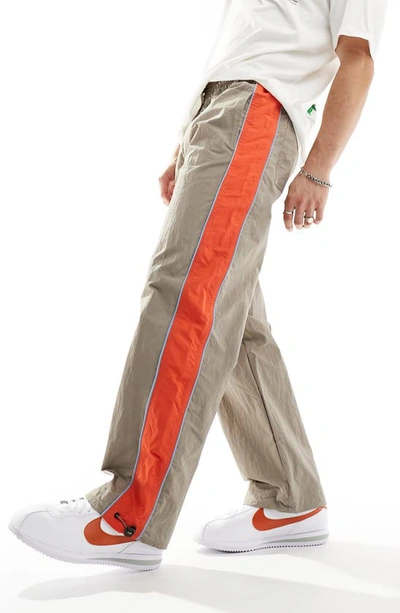 Shop Asos Design Stripe Panel Nylon Wide Leg Drawstring Track Pants In Brown