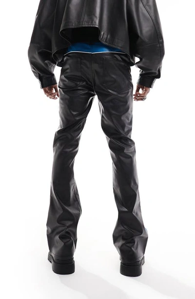 Shop Asos Design Faux Leather Colorblock Flare Pants In Black
