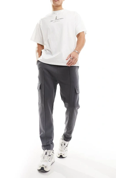 Shop Asos Design Tapered Cotton Cargo Joggers In Charcoal