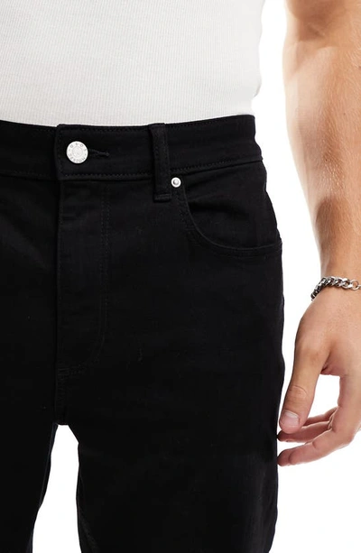Shop Asos Design Tapered Jeans In Black