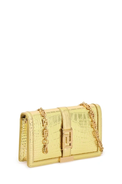 Shop Versace Croco-embossed Leather Greca Goddes Crossbody Bag Women In Gold