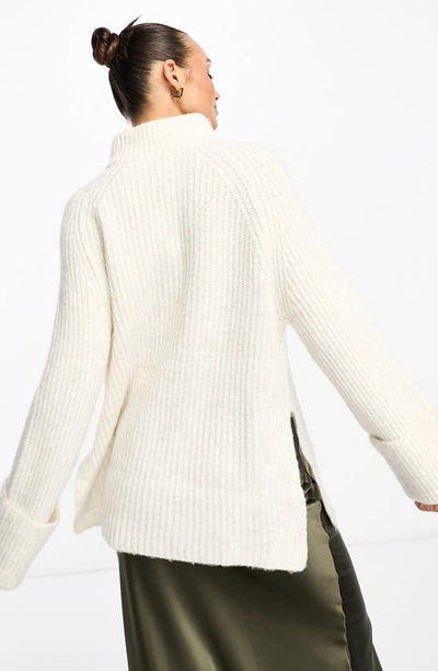 Shop Asos Design Side Slit Mock Neck Sweater In Cream