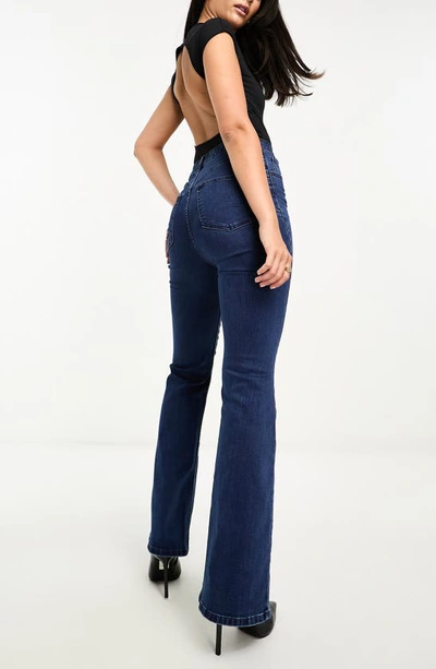 Shop Asos Design Power Stretch High Waist Flare Jeans In Dark Blue