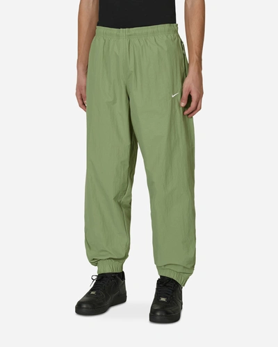 Shop Nike Solo Swoosh Woven Track Pants Green In Multicolor