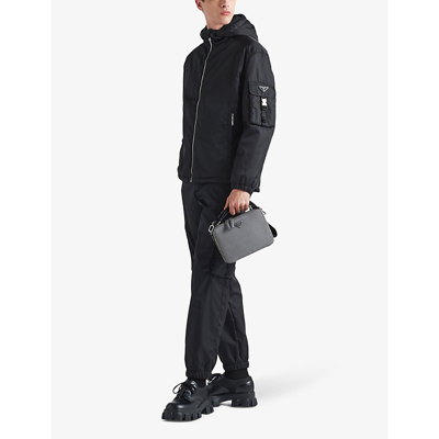 Shop Prada Mens Black Re-nylon Buckle-embellished Tapered Slim-fit Recycled-nylon Trousers
