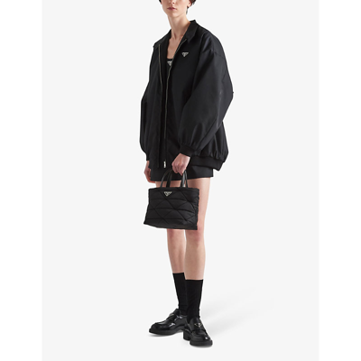 Prada Small Re-nylon Logo Plaque Top Handle Bag In Black