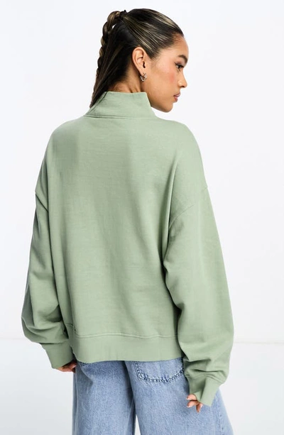 Shop Asos Design Washed Half Zip Sweatshirt In Mid Green