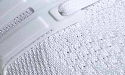 Shop Adidas Originals Kids' Ubounce Dna Running Sneaker In White/ White/ Black