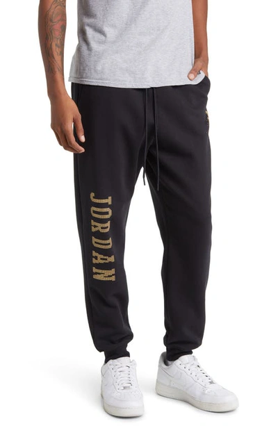 Shop Jordan Essentials Holiday Joggers In Black/ Metallic Gold