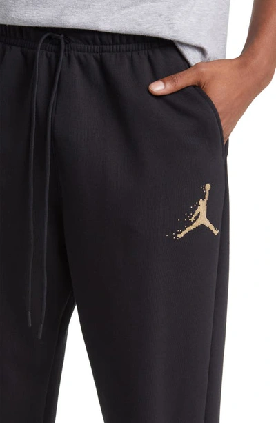 Shop Jordan Essentials Holiday Joggers In Black/ Metallic Gold