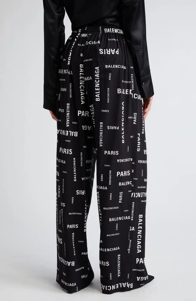 Shop Balenciaga Paris Print Wide Leg Pants In Black/ White