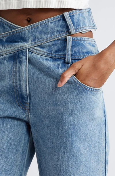 Shop Monse Crisscross Waist Raw Hem Wide Leg Jeans In Indigo
