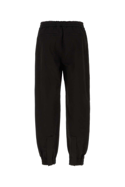 Shop Alexander Mcqueen Mid-rise Tapered-leg Trousers In Black