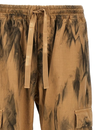 Shop Msgm Dirty-effect Cargo Pants In Beige