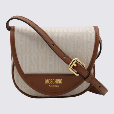 Shop Moschino Ivory Canvas And Leather Allover Crossbody Bag In White