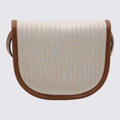 Shop Moschino Ivory Canvas And Leather Allover Crossbody Bag In White