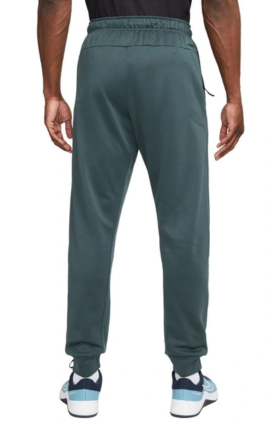 Shop Nike Therma-fit Tapered Training Pants In Deep Jungle/ Black