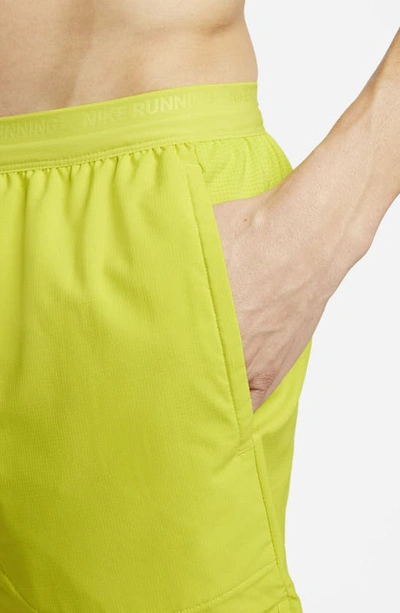 Shop Nike Dri-fit Stride 7-inch Brief-lined Running Shorts In Bright Cactus/moss