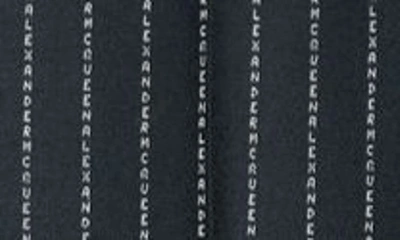 Shop Alexander Mcqueen Logo Jacquard Wool Cigarette Trousers In Black White