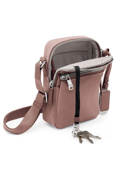 Shop Tumi Persia Crossbody Bag In Light Mauve