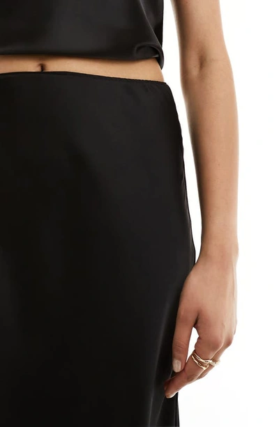 Shop Asos Design Bias Cut Satin Midi Skirt In Black