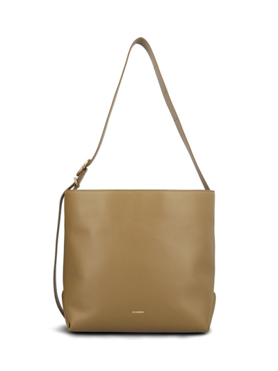Shop Jil Sander Cannolo Logo Printed Shoulder Bag In Brown